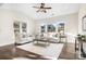 Bright living room with modern decor, hardwood floors, and large windows at 5367 Heartwood Ln, Denver, NC 28037