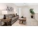 Comfortable living room with a plush sofa, stylish decor, and ample natural light for a cozy atmosphere at 5367 Heartwood Ln, Denver, NC 28037