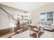 Open-concept living room flows into a modern kitchen with stainless steel appliances, hardwood flooring, and natural light at 5367 Heartwood Ln, Denver, NC 28037