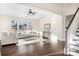 Spacious living room with hardwood floors, a ceiling fan, and plenty of natural light at 5367 Heartwood Ln, Denver, NC 28037