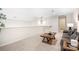 Cozy loft area with plush carpeting, a comfortable sofa, and natural light, creating a relaxing retreat at 5367 Heartwood Ln, Denver, NC 28037