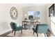 Bright office with a neutral color palette, stylish rug, modern desk, and comfortable chairs at 5367 Heartwood Ln, Denver, NC 28037