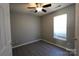 This bedroom features modern grey walls, a ceiling fan and a window for natural light at 5809 Carolina Manor Ct, Indian Trail, NC 28079