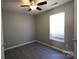 This cozy bedroom features modern grey walls, a ceiling fan and a window for natural light at 5809 Carolina Manor Ct, Indian Trail, NC 28079