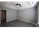 This bedroom features grey wood floors, light grey walls and a tray ceiling with fan at 5809 Carolina Manor Ct, Indian Trail, NC 28079