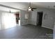 Open-concept living room with luxury vinyl plank flooring and modern ceiling fan at 5809 Carolina Manor Ct, Indian Trail, NC 28079