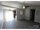 Open-concept living room with luxury vinyl plank flooring and modern ceiling fan at 5809 Carolina Manor Ct, Indian Trail, NC 28079