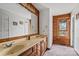 Bathroom featuring a vanity with dual sinks, framed mirror, and wood paneled accents at 5912 Potter S Rd, Waxhaw, NC 28173