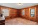 An unfinished bedroom with wood paneled walls and three windows offering an abundance of natural light at 5912 Potter S Rd, Waxhaw, NC 28173