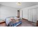 Bedroom with carpet, paneled walls, and a full closet at 5912 Potter S Rd, Waxhaw, NC 28173