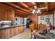 Wood kitchen featuring oak cabinets, white appliances, washer/dryer, dining area, and wood paneling at 5912 Potter S Rd, Waxhaw, NC 28173