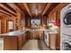 Kitchen with wood paneling, ceiling beams, oak cabinets, and white appliances at 5912 Potter S Rd, Waxhaw, NC 28173