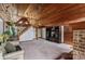 An open living room with wood-paneled walls and ceilings and a striking staircase to a loft or second level at 5912 Potter S Rd, Waxhaw, NC 28173