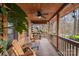 Relaxing covered porch with wood railings, ceiling fan, and comfortable seating at 5912 Potter S Rd, Waxhaw, NC 28173