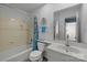 Well-maintained bathroom with a shower-tub combo, blue accents, and a large vanity at 7138 Stonington Ln, Charlotte, NC 28227