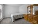 Bright bedroom features neutral tones and a full mirrored dresser set at 7138 Stonington Ln, Charlotte, NC 28227