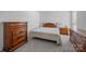 Bedroom with neutral-colored walls featuring a queen-size bed and wooden dressers at 7138 Stonington Ln, Charlotte, NC 28227