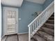 View of the stairway leading to the second story, with the front door to the left at 7138 Stonington Ln, Charlotte, NC 28227