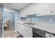 Kitchen with white cabinets, countertops, and sink with hardwood flooring at 7138 Stonington Ln, Charlotte, NC 28227