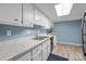 Kitchen with white cabinets, countertops, and sink with hardwood flooring at 7138 Stonington Ln, Charlotte, NC 28227
