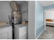 Neat laundry room featuring white washer and dryer machines and wire shelving at 7138 Stonington Ln, Charlotte, NC 28227