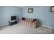 Cozy living room with blue walls, comfy couch, and classic television set at 7138 Stonington Ln, Charlotte, NC 28227