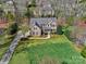 Aerial view of a beautiful brick home with manicured lawn and landscaping, showcasing curb appeal at 8017 Talcott Dr, Mint Hill, NC 28227