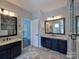 This bathroom features a double sink vanity with granite counters and a large mirror at 8017 Talcott Dr, Mint Hill, NC 28227