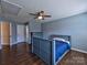 Cozy bedroom with stylish blue walls, wood floors, and a ceiling fan at 8017 Talcott Dr, Mint Hill, NC 28227