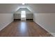 Bonus room area featuring hardwood floors, built-in shelving, and a window at 8017 Talcott Dr, Mint Hill, NC 28227