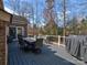 Outdoor deck area featuring a dining table, chairs, and grill with a peaceful backyard view at 8017 Talcott Dr, Mint Hill, NC 28227
