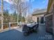 Outdoor deck area featuring a dining table and chairs with a peaceful backyard view at 8017 Talcott Dr, Mint Hill, NC 28227