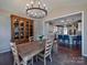 Charming dining area with a rustic table, hutch, and view of the modern kitchen at 8017 Talcott Dr, Mint Hill, NC 28227