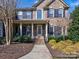 Charming front porch with decorative columns and landscaping providing a beautiful entrance to the home at 8017 Talcott Dr, Mint Hill, NC 28227