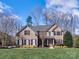 Beautiful two-story brick home with a well-manicured lawn and meticulously kept landscaping at 8017 Talcott Dr, Mint Hill, NC 28227