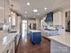 Bright kitchen featuring white cabinets, stainless steel appliances, and a center island at 8017 Talcott Dr, Mint Hill, NC 28227