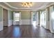 Elegant living room with hardwood floors, detailed trim, and beautiful windows with natural light at 8017 Talcott Dr, Mint Hill, NC 28227