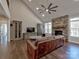 Spacious living room with stone fireplace, high ceiling, and open layout to kitchen at 8017 Talcott Dr, Mint Hill, NC 28227