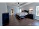 The main bedroom features a ceiling fan, lamps on either side of the bed, and hardwood floors at 8017 Talcott Dr, Mint Hill, NC 28227