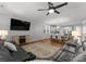 Spacious living room with hardwood floors, a ceiling fan, and an open layout to the dining area at 809 Cadence Park Pl, Fort Mill, SC 29708