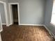 Cozy room with hardwood floors, a window with blinds, and a closet at 821 S Oakland St, Gastonia, NC 28054