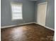 Bedroom showcasing hardwood floors, a window with blinds, and a closet at 821 S Oakland St, Gastonia, NC 28054