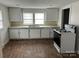 Bright kitchen with white cabinets and appliances, and two windows at 821 S Oakland St, Gastonia, NC 28054
