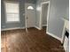 Inviting living room featuring hardwood floors, a window with blinds and a fireplace at 821 S Oakland St, Gastonia, NC 28054