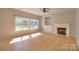 Sun-filled living room with fireplace and built-in shelving at 8414 Bampton Dr, Concord, NC 28027