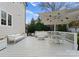 Backyard deck features white outdoor furniture, including wicker sofa and table with umbrella coverage at 846 Wriston Pl, Charlotte, NC 28209