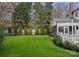 Manicured backyard with a trampoline, level lawn, screened-in porch and decorative trees in the background at 846 Wriston Pl, Charlotte, NC 28209