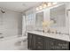 Bathroom with a double vanity, marble countertops, and a shower-tub combination at 846 Wriston Pl, Charlotte, NC 28209
