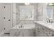 Elegant bathroom featuring a soaking tub, marble accents, and bright natural light from the window at 846 Wriston Pl, Charlotte, NC 28209