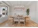 Elegant dining room with modern light fixture, neutral wallpaper, and decorative wainscoting at 846 Wriston Pl, Charlotte, NC 28209
